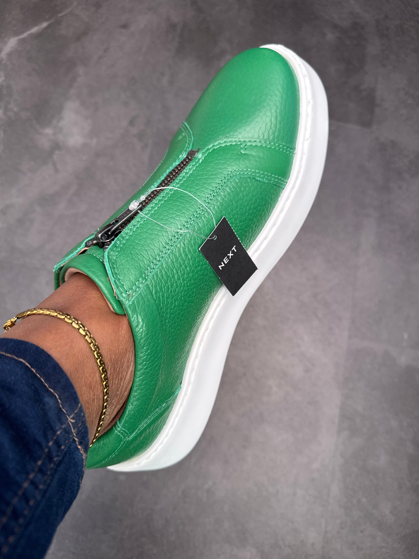 Green slip on sneakers zip detail