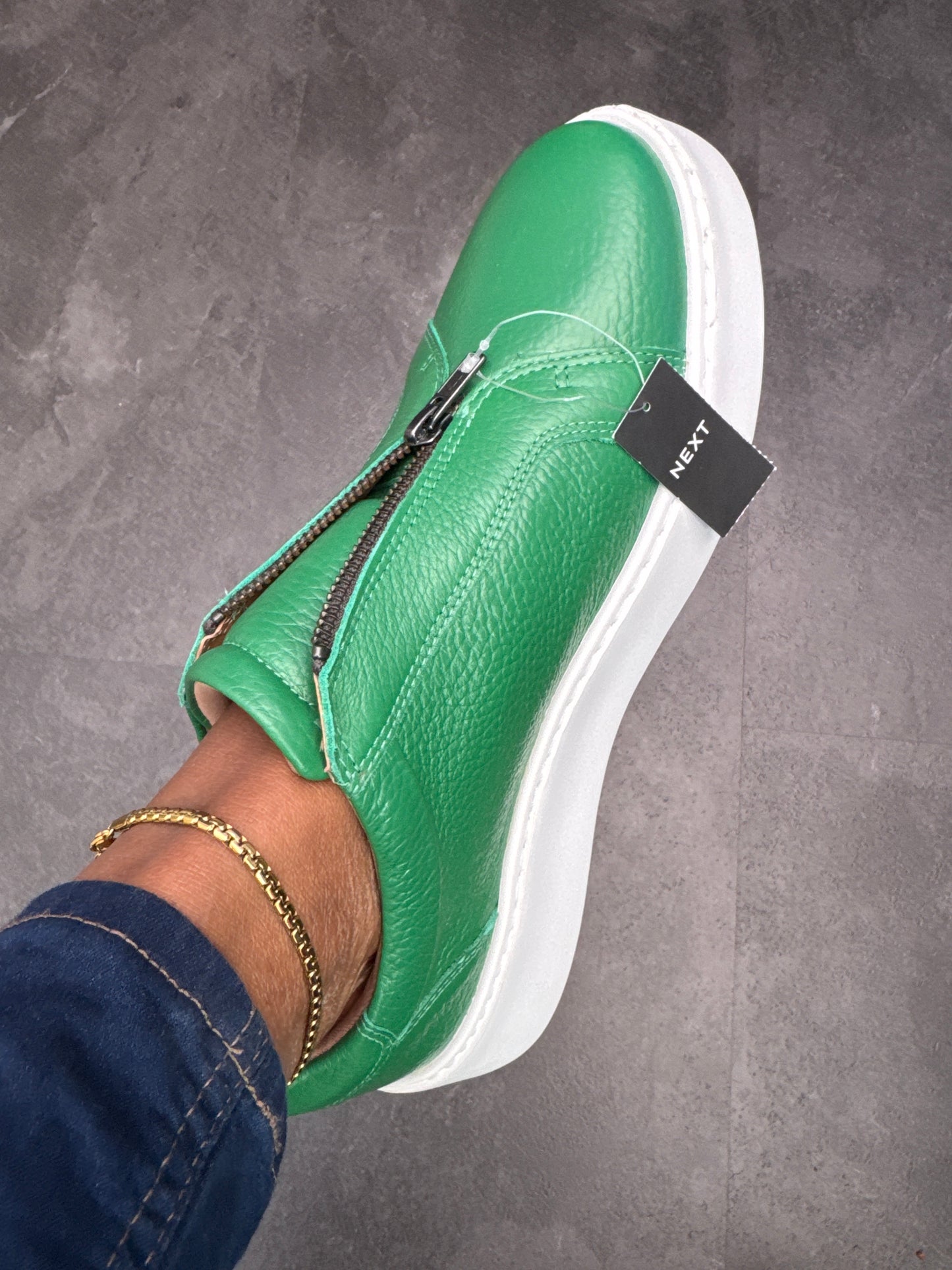 Green slip on sneakers zip detail