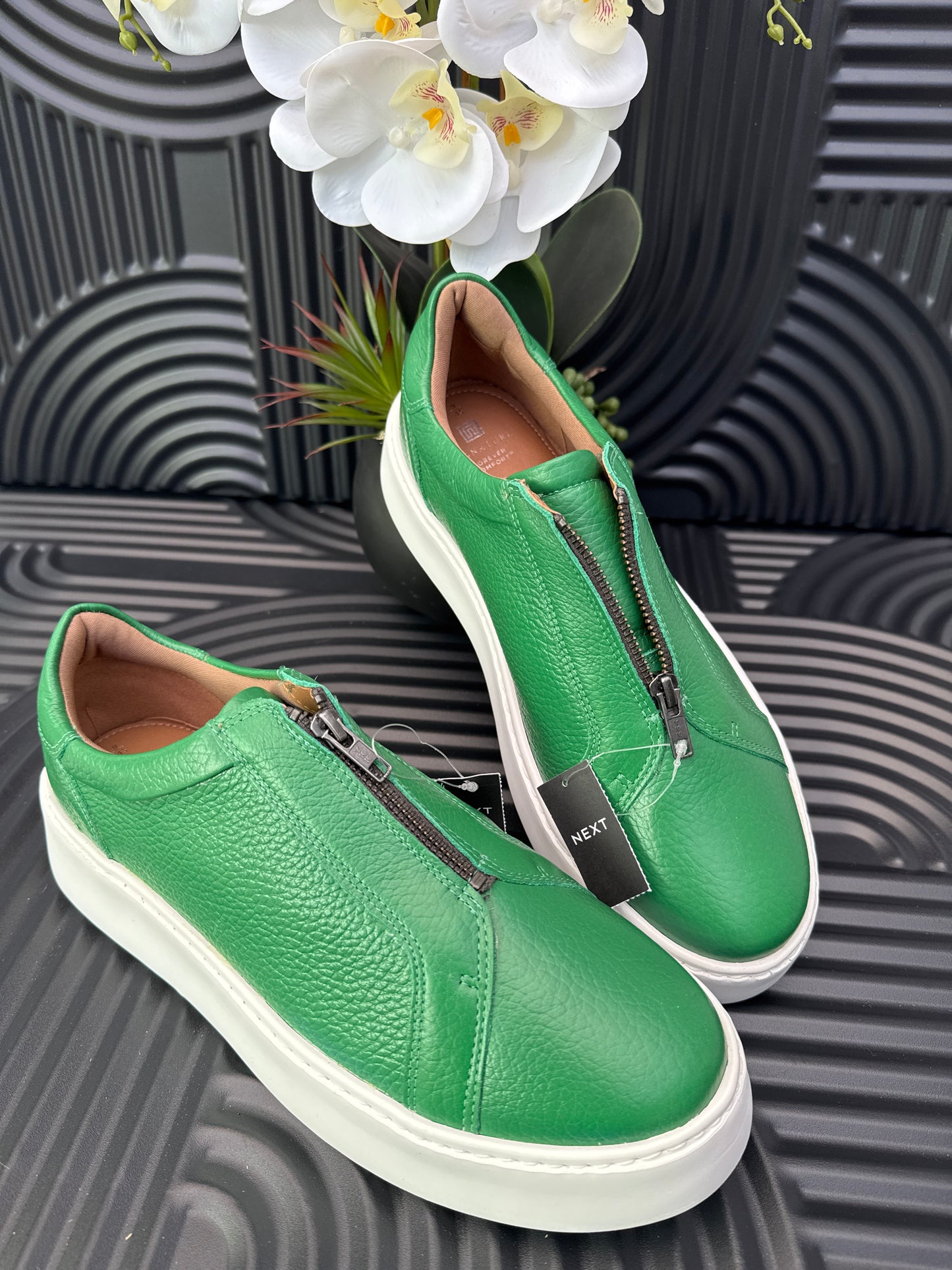 Green slip on sneakers zip detail