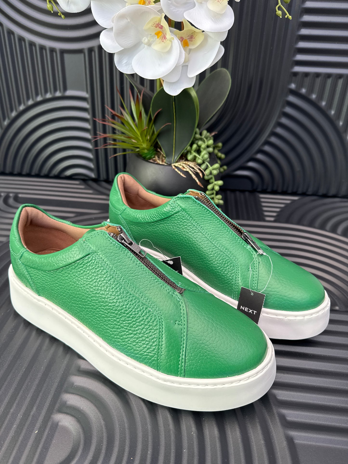 Green slip on sneakers zip detail